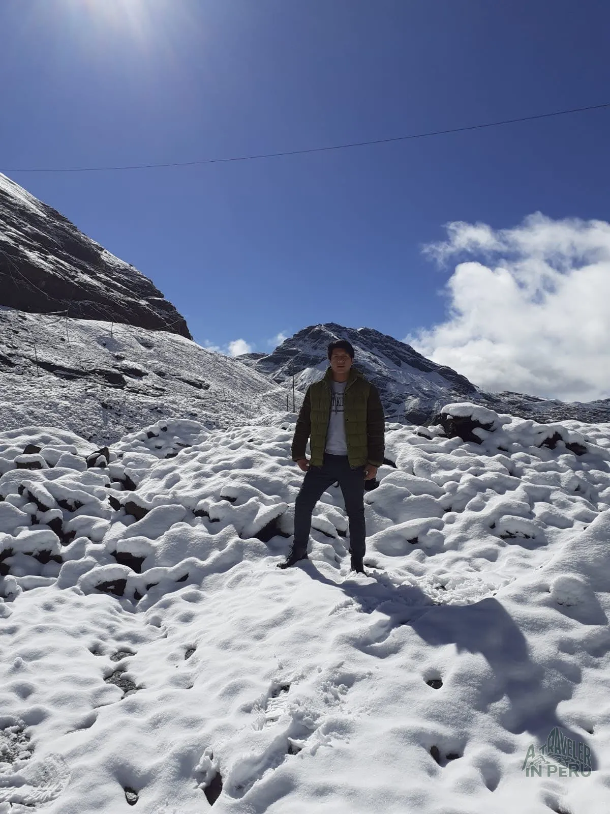 At the peak of the snowy mountain feeling the cold of the Andes